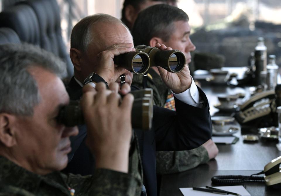 FILE In this file photo taken on Thursday, Sept. 13, 2018, Russian President Vladimir Putin, center, holds binoculars while watching a military exercises on training ground "Telemba", about 80 kilometers (50 miles ) north of the city of Chita during the military exercises Vostok 2018 in Eastern Siberia, Russia . Russian Defense Minister Sergei Shoigu is on the left. U.S. and European sanctions have restricted Russia’s access to international capital markets, limited imports of Western energy and military technologies and spooked international investors. (Alexei Nikolsky, Sputnik, Kremlin Pool Photo via AP, File)