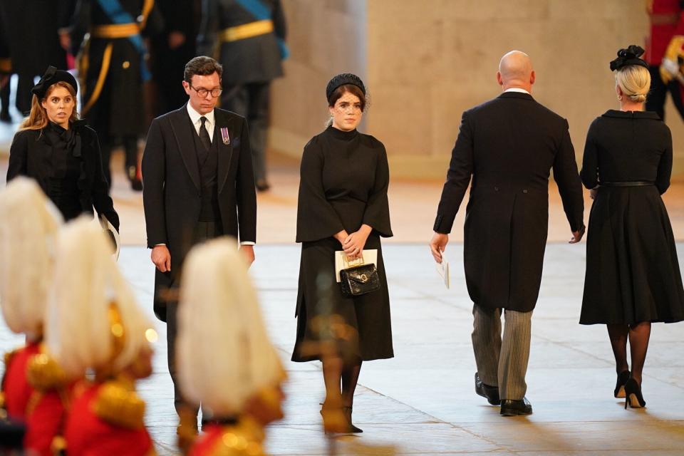 Princess Beatrice, left, Jack Brooksbank and Princess Eugenie look on as the coffin of Queen Elizabeth II sits on the catafalque in Westminster Hall