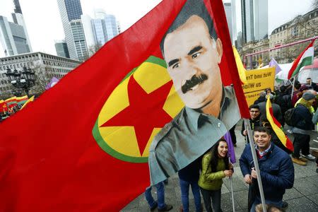 People carry a flag with the picture of imprisoned Kurdish rebel leader Abdullah Ocalan during a demonstration organised by Kurds, in Frankfurt, Germany, March 18, 2017. REUTERS/Ralph Orlowski