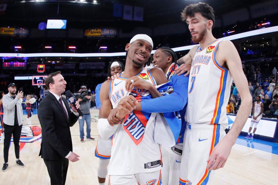 OKC's Shai Gilgeous-Alexander, left, Jalen Williams, center, and Chet Holmgren (7) joke around after a win against the Wizards on Feb. 23 at Paycom Center.