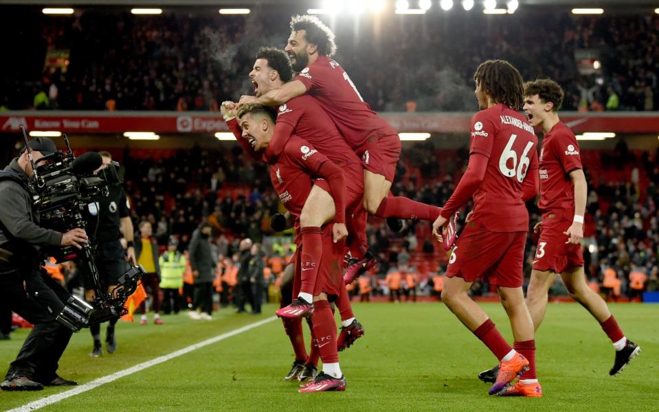 Liverpool players celebrate after Roberto Firmino put them 7-0 ahead against United at Anfield last season...