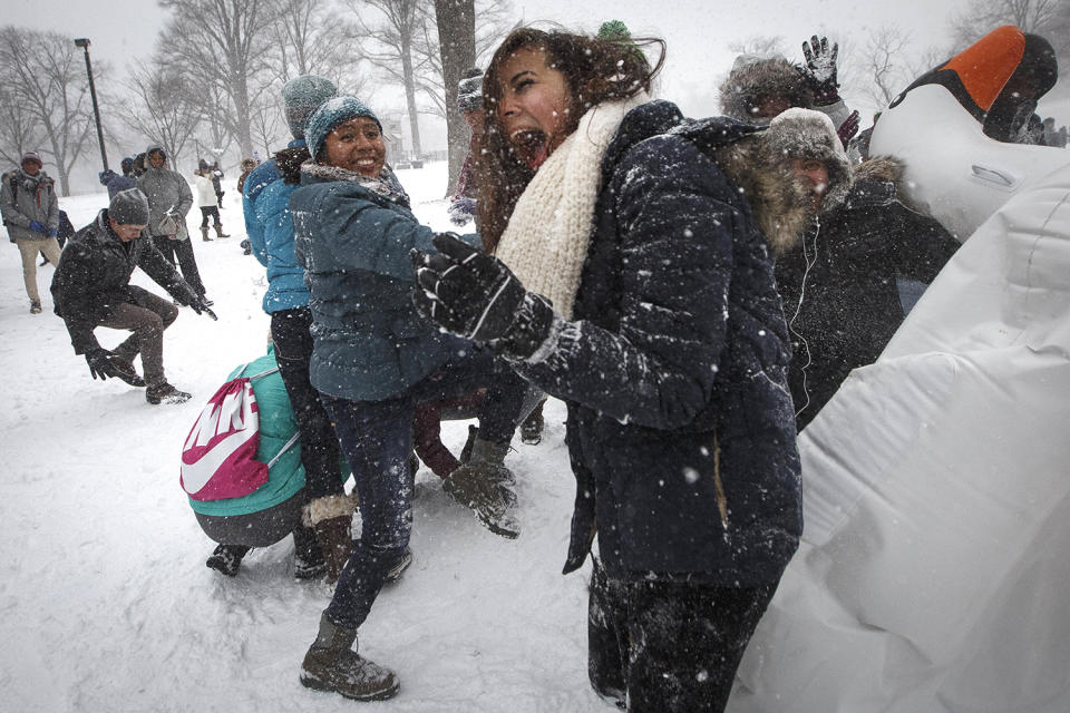 <p>A woman reacts to being hit by a snowball during a snowball fight in the Boston Common on Feb. 9, 2017. A powerful, fast-moving storm swept through the northeastern U.S. Thursday, making for a slippery morning commute and leaving some residents bracing for blizzard conditions. (Photo: Keith Bedford/The Boston Globe via Getty Images) </p>