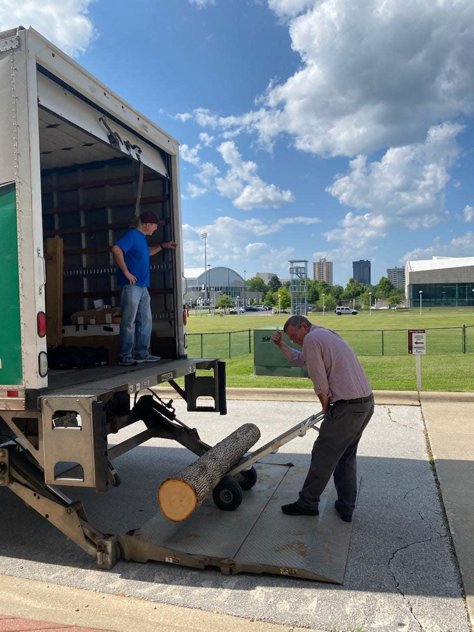 Missouri State University Dean of Libraries Thomas Peters loads a white oak log into the back of a U-Haul on Missouri State's campus. Peters transported four six-foot white oak logs from Springfield to Washington D.C. for the annual Smithsonian Folklife Festival.