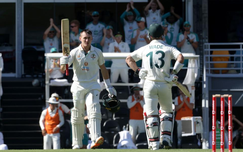 Australia's batsman Marnus Labuschagne (L) celebrates reaching his century (100 runs) on day one of the fourth cricket Test match between Australia and India - AFP