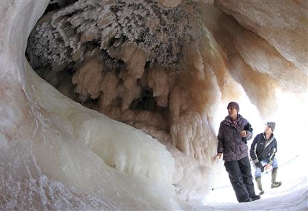 Sightseers look at ice formations in sea caves of the Apostle Islands National Lakeshore of Lake Superior near Cornucopia, Wisconsin February 14, 2014. REUTERS/Eric Miller