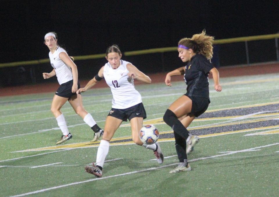 Licking Heights' Elizabeth Killey battles Watkins Memorial's Jaylyn Thornton during the visiting Hornets' 3-1 victory at Ascena Field.