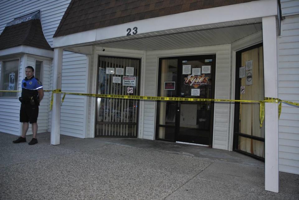 A Lexington police officer stands outside Fyre Entertainment, a local Lexington business, after an officer shot a suspect near the business.