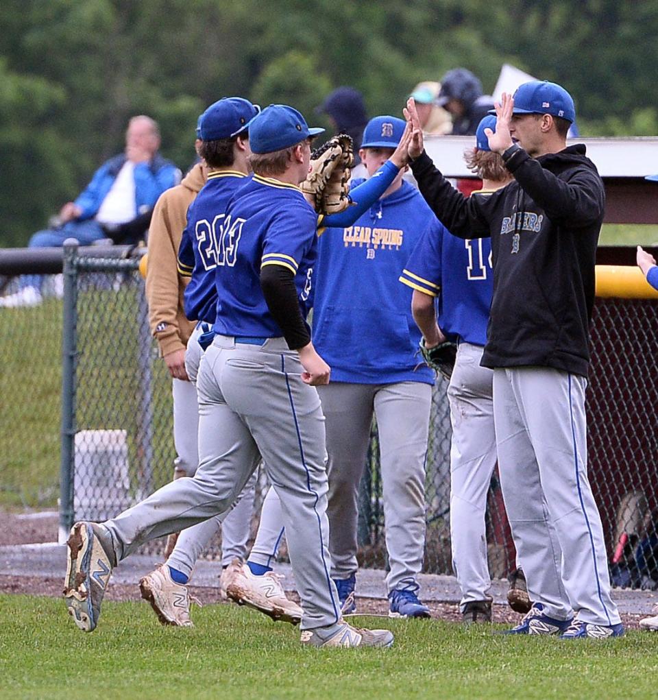 Clear Spring coach Brandon Glazer high-fives his players as they come off the field between innings at Brunswick.