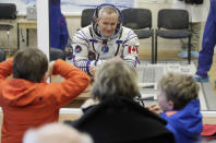 CSA astronaut David Saint Jacques, member of the main crew of the expedition to the International Space Station (ISS), speaks with his relatives through a safety glass prior to the launch of Soyuz MS-11 space ship at the Russian leased Baikonur cosmodrome, Kazakhstan, Monday, Dec. 3, 2018. (AP Photo/Dmitri Lovetsky, Pool)