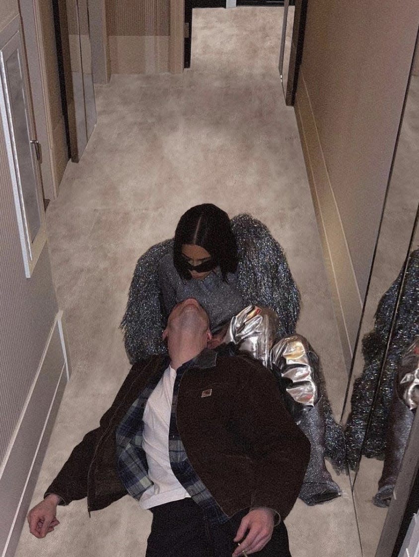 Kim Kardashian and Pete Davidson sitting together on a carpeted floor