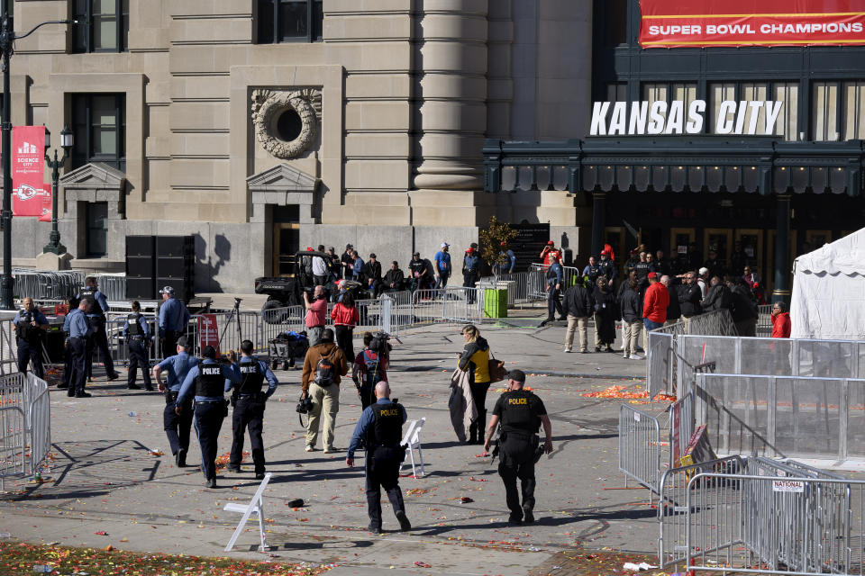 Law enforcement personnel approach Union Station following a shooting at the Kansas City Chiefs NFL football Super Bowl celebration in Kansas City, Mo., Wednesday, Feb. 14, 2024. Multiple people were injured, a fire official said. (AP Photo/Reed Hoffmann)