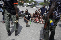 Police officers stop and search a bus carrying passengers around Lekki toll gate in Lagos Friday, Oct. 23, 2020. Resentment lingered with the smell of charred tires Friday as Nigeria's streets were relatively calm after days of protests over police abuses, while authorities gave little acknowledgement to reports of the military killing at least 12 peaceful demonstrators earlier this week. (AP Photo/Sunday Alamba)