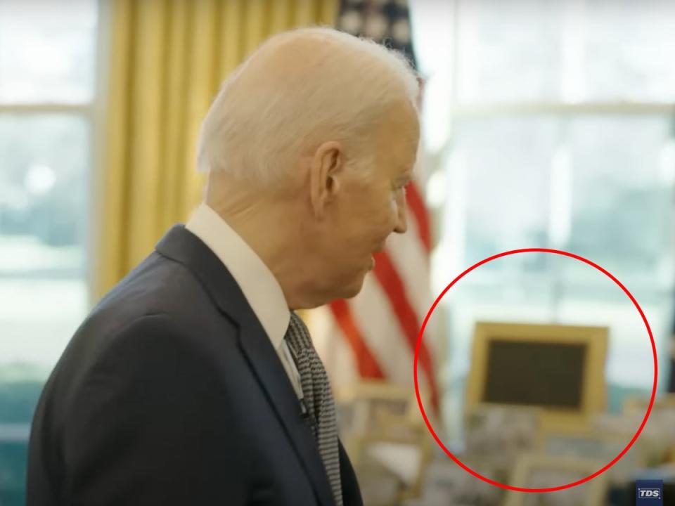 The apparent TV in a gold frame that President Biden is said to watch in the Oval Office (The Daily Show / The Independent)