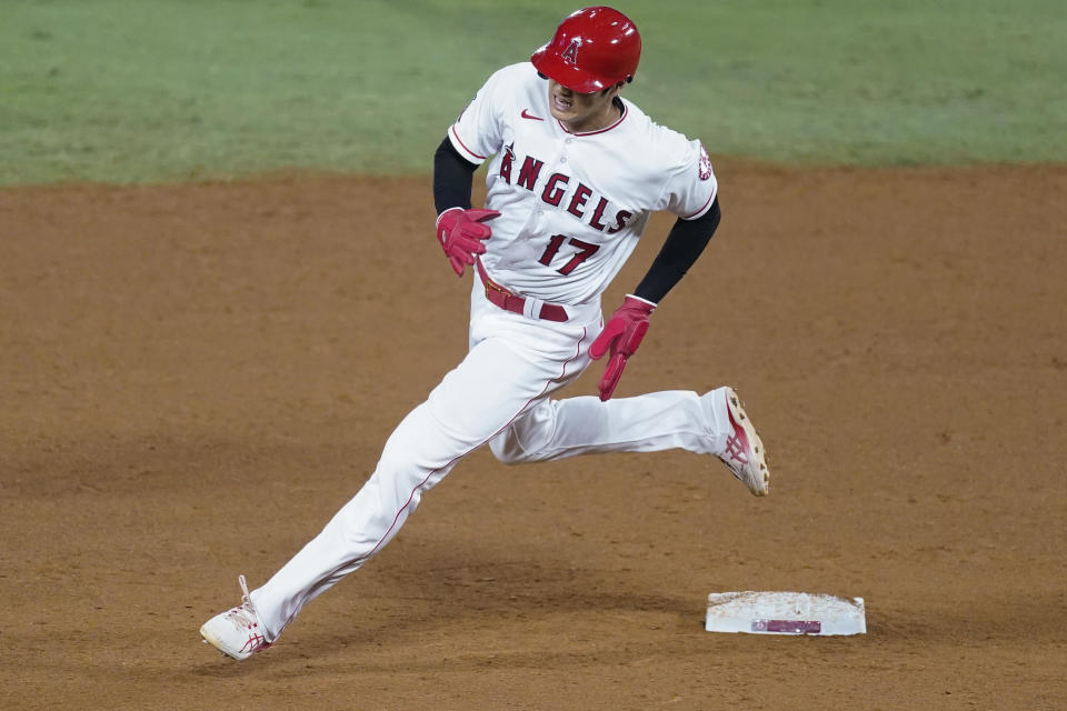 Los Angeles Angels designated hitter Shohei Ohtani rounds second base after a double by Taylor Ward during the fifth inning of a baseball game against the Texas Rangers, Saturday, Sept. 19, 2020, in Anaheim, Calif. (AP Photo/Ashley Landis)