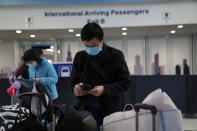 Passengers from United flight UA850 direct from Beijing arrive at Terminal 5 at O'Hare International Airport, Friday, Jan. 24, 2020 in Chicago. A Chicago woman has become the second U.S. patient diagnosed with the dangerous new virus from China, health officials announced Friday. (E. Jason Wambsgans/Chicago Tribune via AP)