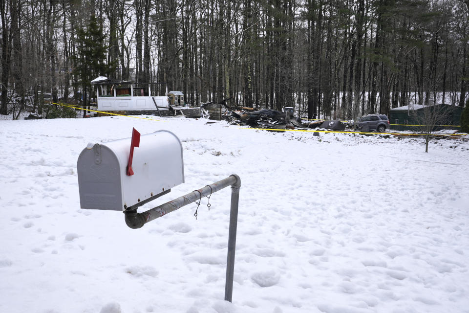 The remains of a residential home, which exploded after a tree fell on propane tanks during a severe storm, is surrounded by caution tape, Friday, April 5, 2024, in Derry, N.H. Hundreds of thousands of homes and businesses are still without power in Maine and New Hampshire following Thursday's storm. One woman died in the home explosion. (AP Photo/Charles Krupa)