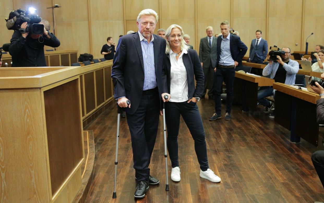 Boris Becker (L) was on crutches for the announcement after undergoing ankle surgery - EPA
