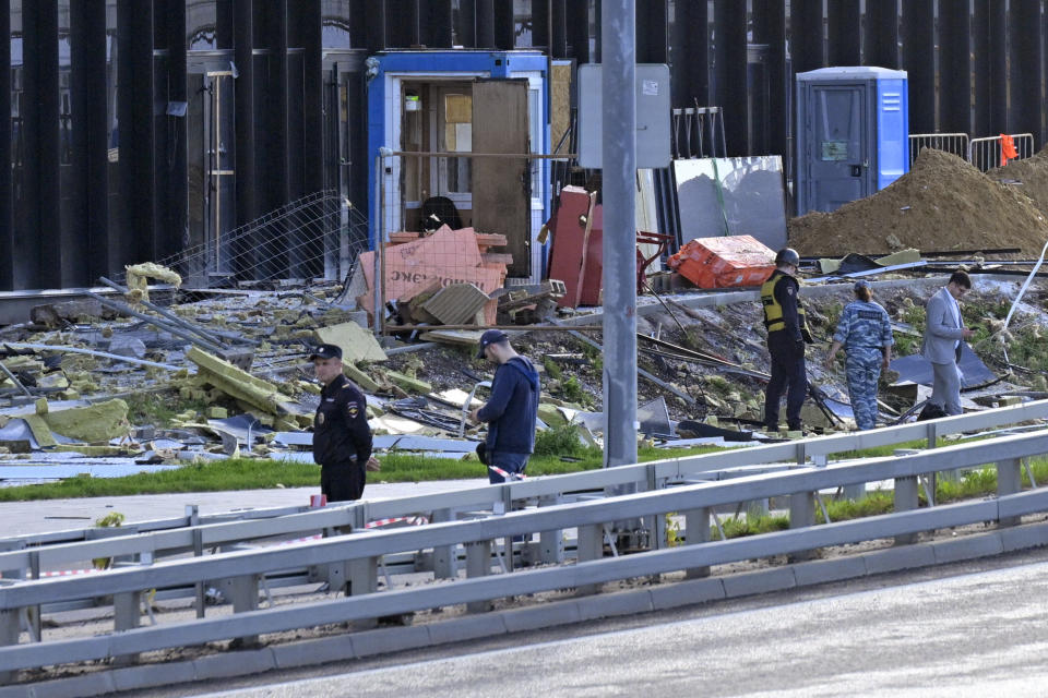 Investigators examine a damaged building after a reported drone attack in Moscow, Russia, Monday, July 24, 2023. (AP Photo)