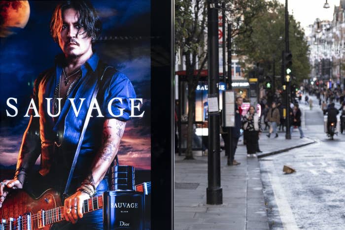 a dior sauvage poster at a bus stop