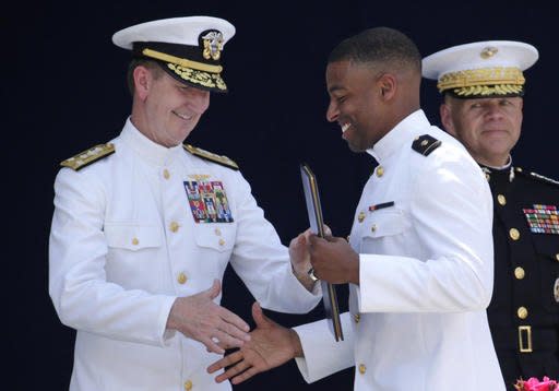 U.S. Naval Academy superintendent Ted Carter, Jr., left, presents a diploma to Keenan Reynolds, graduating Midshipman and the Baltimore Ravens' sixth round NFL draft pick, during the Academy's graduation and commissioning ceremony in Annapolis, Md., Friday, May 27, 2016. U.S. Defense Secretary Ash Carter announced Friday that Reynolds may defer his service and be eligible to play in the NFL in 2016. (AP Photo/Patrick Semansky)