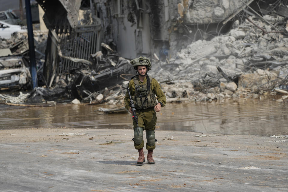 FILE - An Israeli soldier walks outside a police station that was overrun by Hamas militants on Saturday, in Sderot, Israel, Sunday, Oct.8, 2023. Hamas militants stormed over the border fence Saturday, killing hundreds of Israelis in surrounding communities. (AP Photo/Ohad Zwigenberg, File)