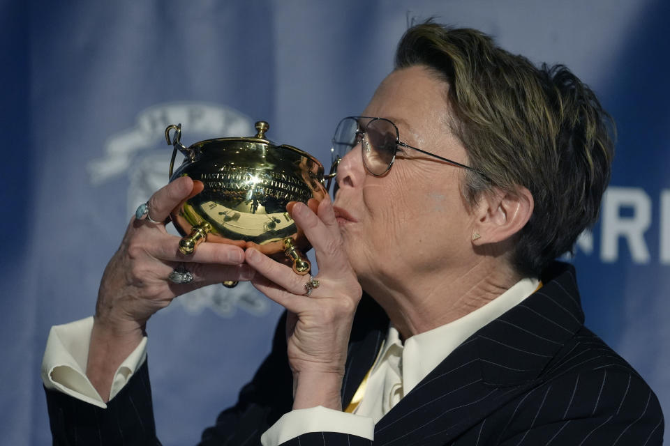 Actor Annette Bening, Hasty Pudding 2024 Woman of the Year, kisses the Pudding Pot during a news conference at Fargas Hall theater, Tuesday, Feb. 6, 2024, in Cambridge, Mass. The award was presented to Bening by Hasty Pudding Theatricals, a theatrical student society at Harvard University. (AP Photo/Steven Senne)