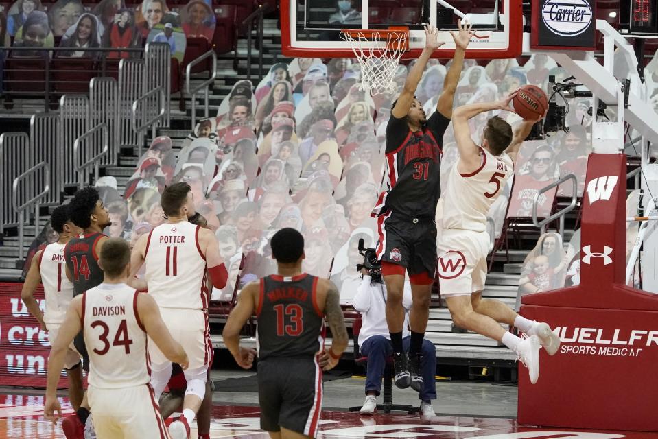 Wisconsin's Tyler Wahl shoots past Ohio State's Seth Towns during the second half of an NCAA college basketball game Saturday, Jan. 23, 2021, in Madison, Wis. (AP Photo/Morry Gash)