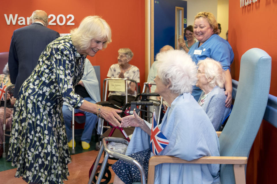 Britain's Queen Camilla speaks with patients at the NHS Lothian's Medicine of the Elderly Meaningful Activity Center during her visit to the Royal Infirmary of Edinburgh, to celebrate 75 years of the NHS at NHS Lothian, as part of the first Holyrood Week since his coronation, Scotland, Tuesday July 4, 2023. (Jane Barlow/Pool Photo via AP)