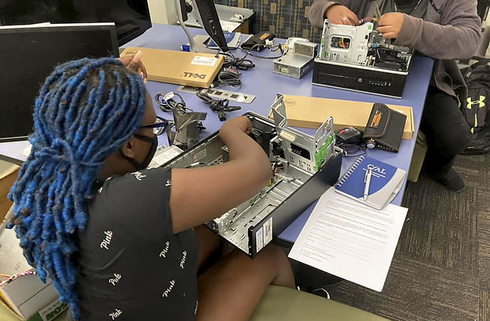 In this undated photo, a Connecticut high school student practices skills she has learned in the Building Your Own Computer program offered by the Connecticut-based group CfAL for Digital Inclusion. States are looking to beef up their residents tech skills as generative artificial intelligence plays a greater role in the workplace. CfAL officials, however, say basic computer skills are also still needed. (Rose Servetnick/CfAL for Digital Inclusion via AP)