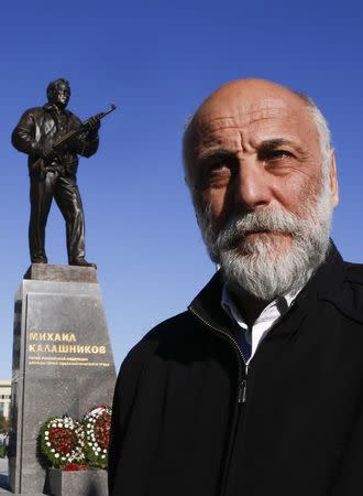 Sculptor Salavat Shcherbakov stands near his creation, a monument to Russian designer of the AK-47 assault rifle Mikhail Kalashnikov, in Moscow, Russia September 22, 2017. REUTERS/Sergei Karpukhin