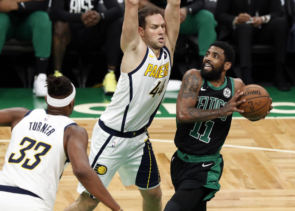 Boston Celtics' Kyrie Irving drives on Indiana Pacers' Bojan Bogdanovic during the first quarter in Game 1 of a first-round NBA basketball playoff series, Sunday, April 14, 2019, in Boston. (AP Photo/Winslow Townson)