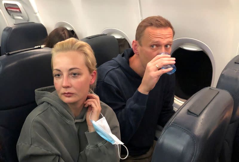 Russian opposition leader Alexei Navalny and his wife Yulia Navalnaya are seen on board a plane during a flight from Berlin to Moscow