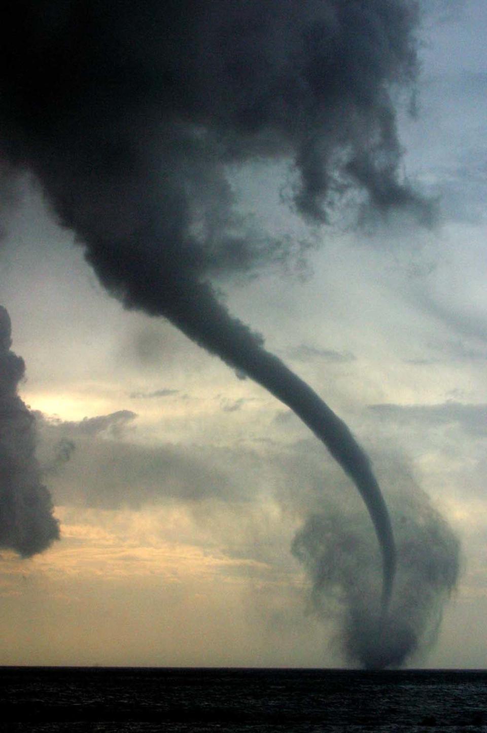 A waterspout builds up off the southern Cypriot coastal town of Limassol, January 27 2003. REUTERS/Andreas Manolis