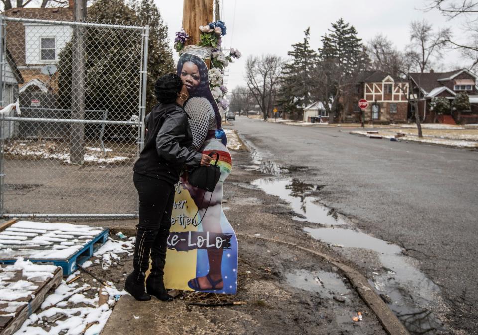 Renee Walker of Detroit in March kisses a cutout of her daughter, LaKisha Walker, near a party store at Whittier Avenue and King Richard Street in Detroit. The driver of an SUV ran over and killed LaKisha Walker in October 2020. u0022It calms me but it ain't her,u0022 Renee Walker said of her daughter's photo. u0022When you lose a loved one it hurts. Every morning I get up, I miss my child every day.u0022