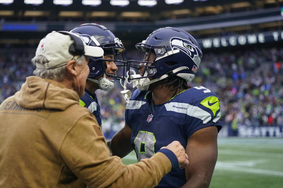 Seattle Seahawks running back Kenneth Walker III, right, celebrates with wide receiver Jaxon Smith-Njigba, center, and left, head coach Pete Carroll, in the second half of an NFL football game in Seattle against the Washington Commanders, Sunday, Nov. 12, 2023. (AP Photo/Lindsey Wasson)