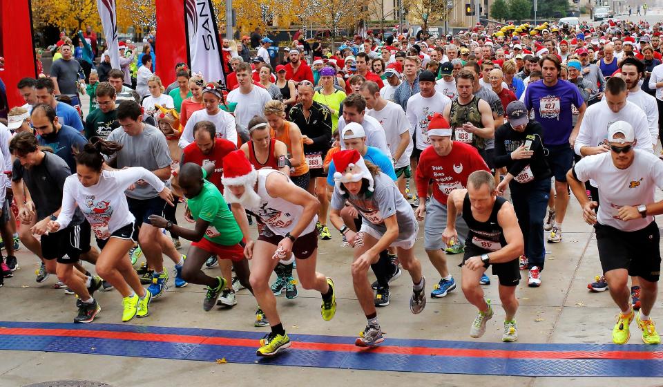 Runners leave the starting line of the 2015 SandRidge 5K Santa Run. Now called the Saints Santa Run, the event is scheduled for Dec. 3 in Oklahoma City.