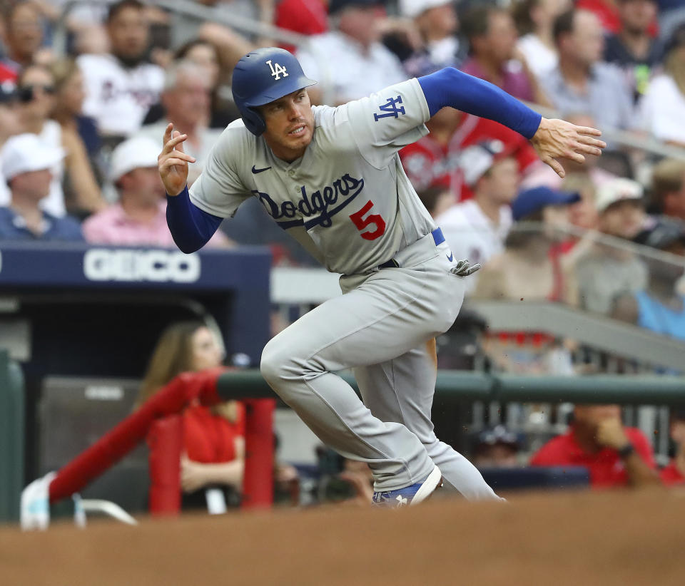 After drawing a walk, Los Angles Dodgers' Freddie Freeman scores a run from third base on a sacrifice fly by Justin Turner against the Atlanta Braves during the first inning of a baseball game on Friday, June 24, 2022, in Atlanta. (Curtis Compton/Atlanta Journal-Constitution via AP)