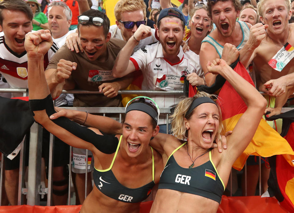 <p>Germany’s Laura Ludwig, right, and Kira Walkenhorst, left, celebrate with fans after defeating Brazil in a women’s beach volleyball semifinal match at the 2016 Summer Olympics in Rio de Janeiro, Brazil, Tuesday, Aug. 16, 2016. (AP Photo/Petr David Josek) </p>