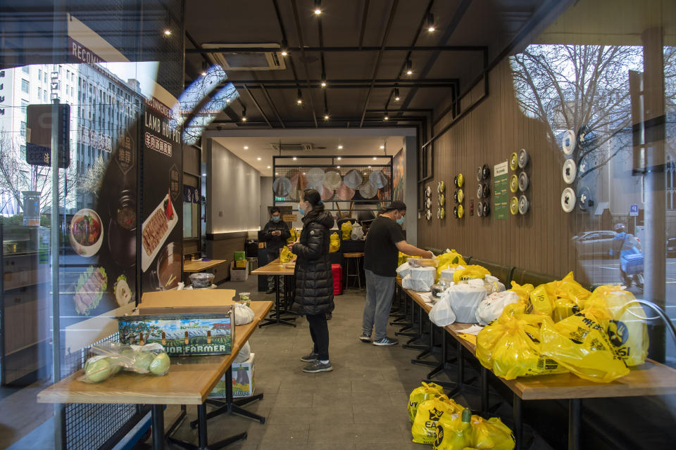 A restaurant prepares delivery meal orders during lockdown due to the continuing spread of the coronavirus in Melbourne, Thursday, Aug. 6, 2020. Victoria state, Australia's coronavirus hot spot, announced on Monday that businesses will be closed and scaled down in a bid to curb the spread of the virus. (AP Photo/Andy Brownbill)