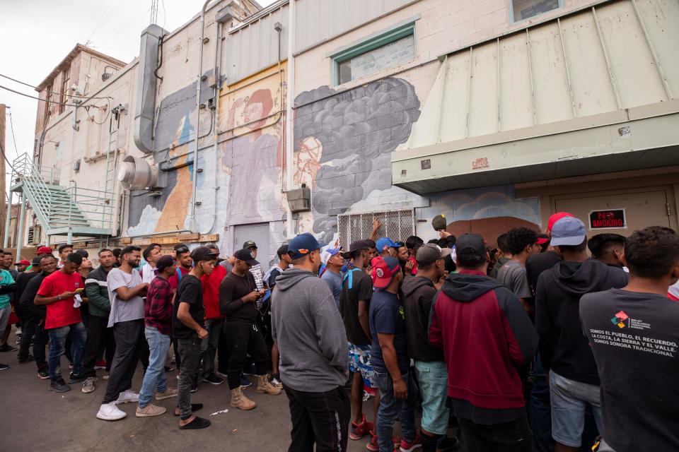 Migrants line up to get fed at the Opportunity Center for the Homeless in El Paso, Texas on May 3, 2023. Hundreds of migrants are seeking refuge at the homeless center. 