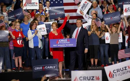 Republican U.S. presidential candidate Ted Cruz raises the arm of his running mate Carly Fiorina at a campaign rally where he announced Fiorina as his choice for Vice Presidential nominee in Indianapolis, Indiana, United States April 27, 2016. REUTERS/Aaron P. Bernstein