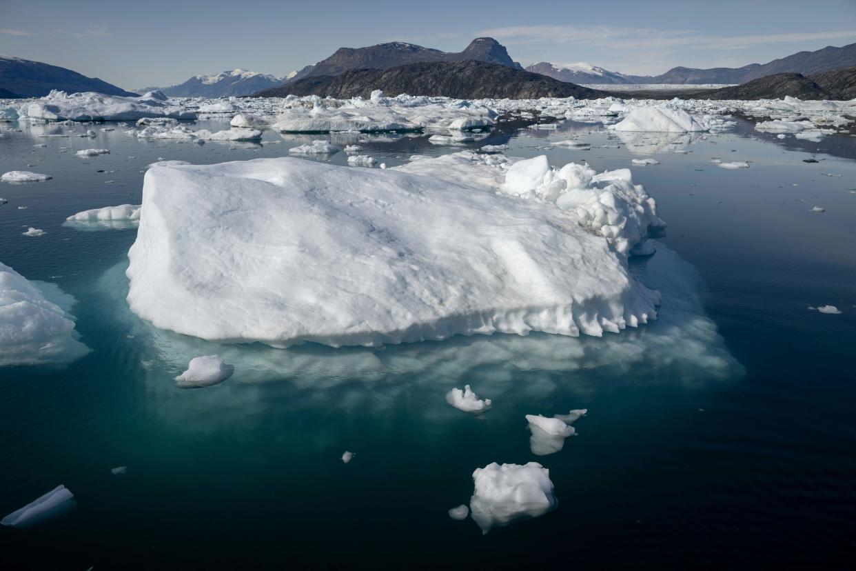 Melting icebergs drift off near a glacier in Scoresby Fjord, Greenland on August 15, 2023. The French National Centre for Scientific Research (CNRS) is undertaking an expedition to explore Greenland's isolated fjords, the planet's largest fjord system, which remains vastly understudied. The expedition, arranged by the volunteer-run French initiative Greenlandia, is dedicated to understanding the climate change's effects on Scoresby Fjord and its inhabitants. (Photo by Olivier MORIN / AFP) (Photo by OLIVIER MORIN/AFP via Getty Images)