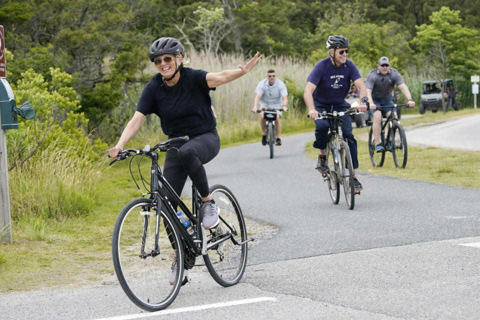 First lady Jill Biden waves as she rides her bike with President Joe Biden in Rehoboth Beach, Del., Thursday, June 3, 2021. The Biden's are spending a few days in Rehoboth Beach to celebrate first lady Jill Biden's 70th birthday. (AP Photo/Susan Walsh)