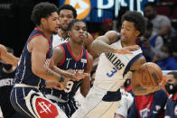 Dallas Mavericks guard Trey Burke (3) looks to pass the ball as Houston Rockets guards Daishen Nix, left, and Josh Christopher (9) defend during the second half of an NBA basketball game, Friday, Jan. 7, 2022, in Houston. (AP Photo/Eric Christian Smith)