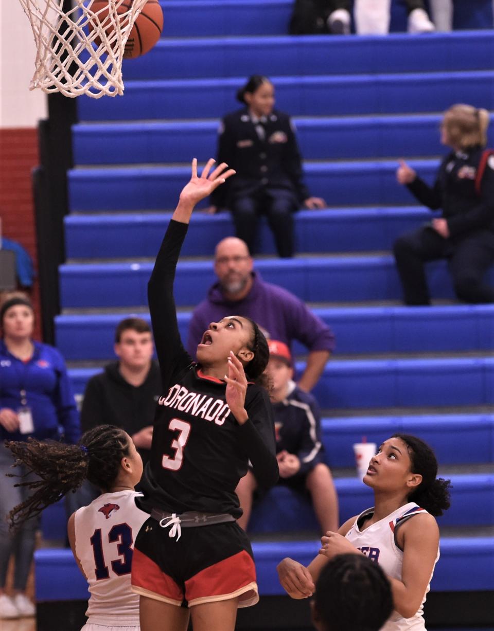 Lubbock Coronado's Jannae-Leigh Cooper (3) drives past the Cooper defense for a layup in the second half.