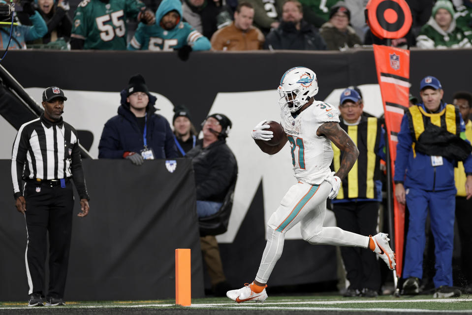 Miami Dolphins running back Raheem Mostert (31) crosses the goal line for a touchdown against the New York Jets during the fourth quarter of an NFL football game, Friday, Nov. 24, 2023, in East Rutherford, N.J. (AP Photo/Adam Hunger)