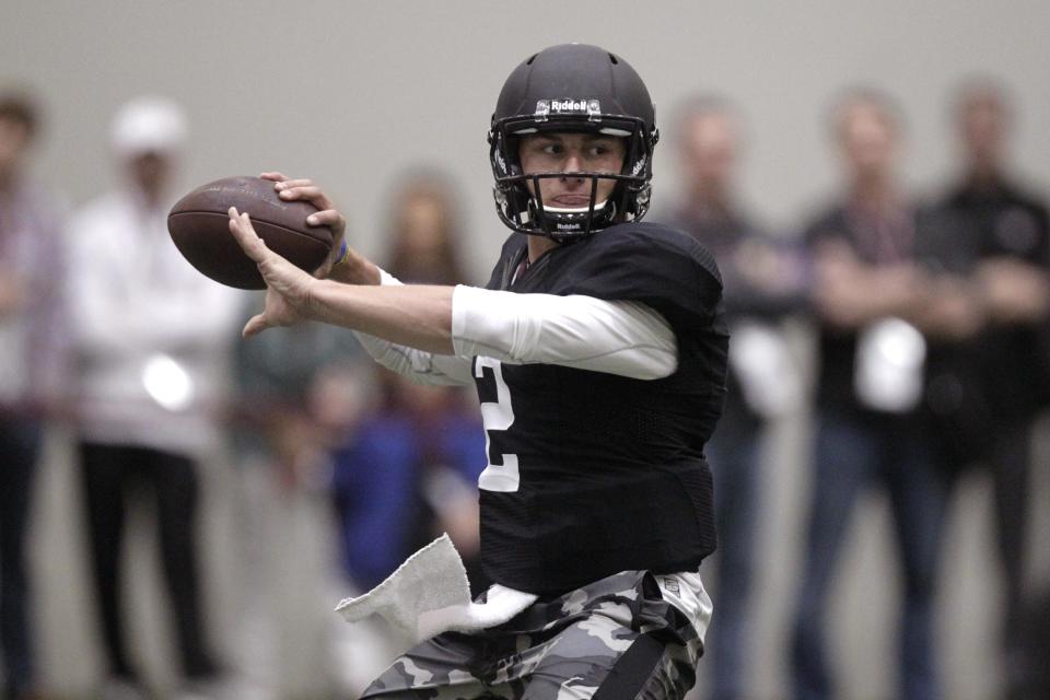 Texas A&M quarterback Johnny Manziel passes the ball during a drill at pro day for NFL football representatives in College Station, Texas, Thursday, March 27, 2014. (AP Photo/Patric Schneider)