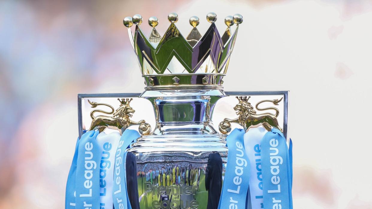  The Premier League trophy with light blue and white streamers. 