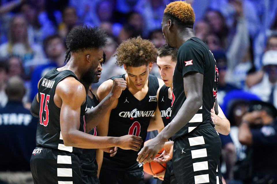 Cincinnati Bearcats forward John Newman III (15), guard Day Day Thomas, guard Dan Skillings Jr. (0), Cincinnati Bearcats guard CJ Fredrick (5) and forward Aziz Bandaogo (55) huddle during the second half of the 91st Crosstown Shootout basketball game between the Cincinnati Bearcats and the Xavier Musketeers, Saturday, Dec. 9, 2023, at Cintas Center in Cincinnati. The Xavier Musketeers won, 84-79.