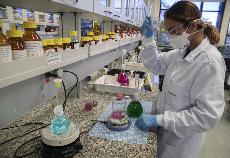 A Uniao Quimica pharmaceutical employee works at the company's control center for the Russian Sputnik V COVID-19 vaccine in Guarulhos in the greater Sao Paulo area of Brazil, Thursday, May 20, 2021. The shot still hasn't been approved for use in Brazil, which prompted local partner Uniao Quimica to begin exports throughout Latin America. (AP Photo/Andre Penner)